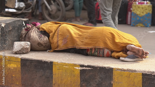 Photography A poor woman sleeping on road