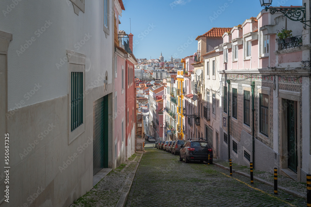 Narrow street with city view and National Pantheon dome on background - Lisbon, Portugal