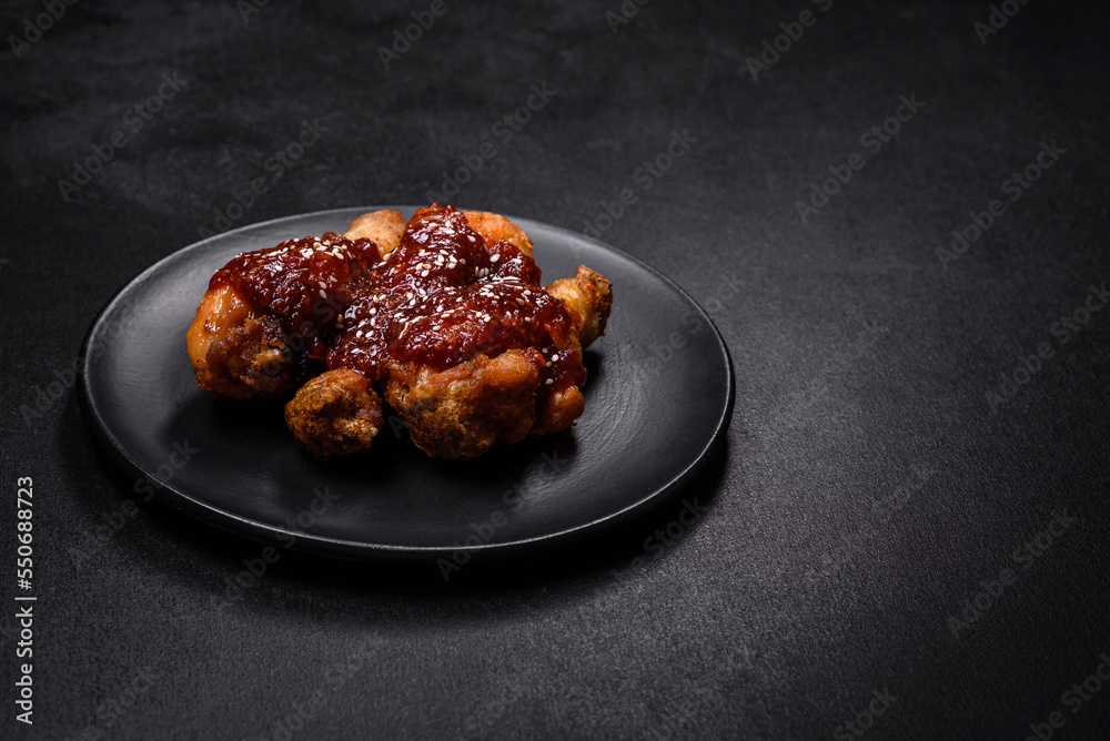 Tasty spicy chicken legs with teriyaki sauce and sesame seeds Tasty spicy chicken legs with teriyaki sauce and sesame seeds