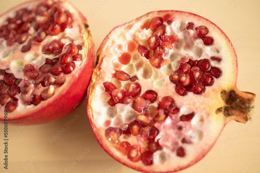large fruit, fruit, pomegranate, cut into two halves with a knife, on a wooden board. Weight loss, proper nutrition, diet, expensive fruits, pomegranate slices. Fruit cutting. cleansing large fruit, fruit, pomegranate, cut into two halves with a knife, on a wooden board. Weight loss, proper nutrition, diet, expensive fruits, pomegranate slices. Fruit cutting. cleansing