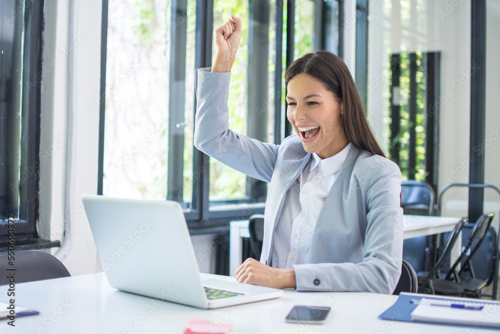 Happy excited woman triumphing with fist up in office. Happy excited woman triumphing with fist up in office.