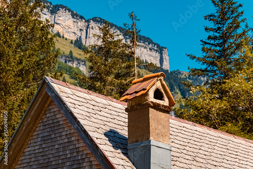 Beautiful alpine summer view with details of a chimney with roof at the famous Seealpsee lake, Appenzell, Alpstein, Switzerland