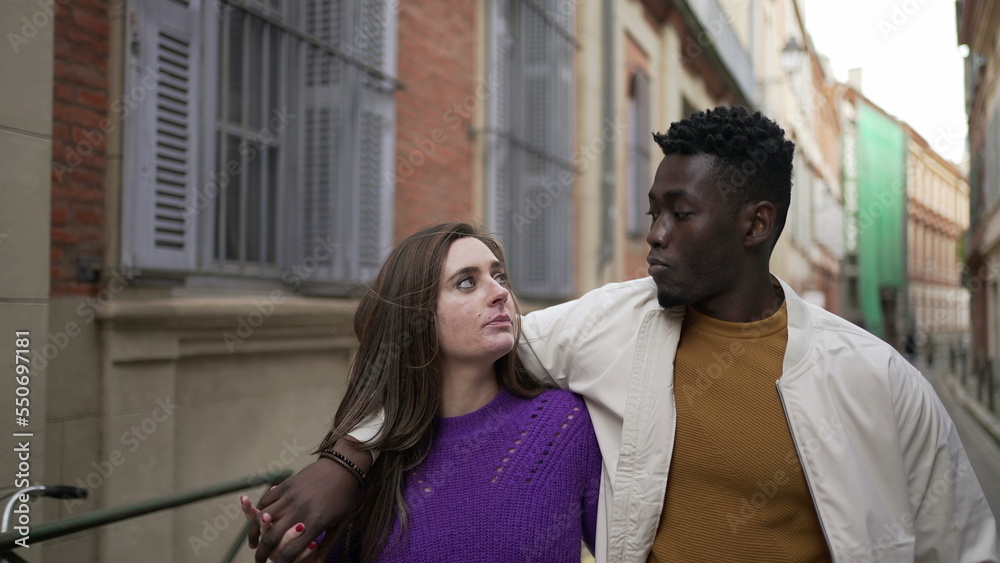 Young romantic interracial couple walking outside in european city2