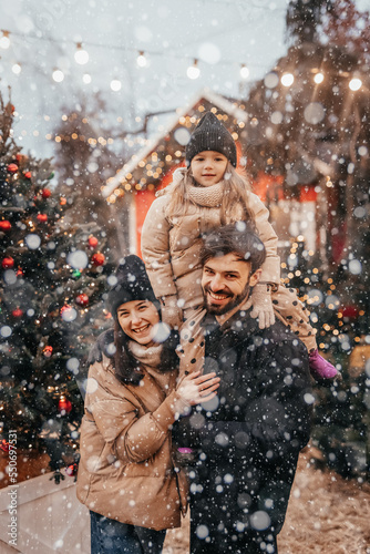 Photo of cheerful family with daughter piggyback happy positive smile look each other winter trip outdoors