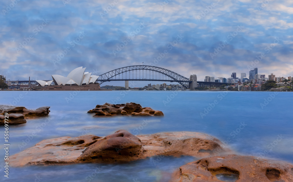 Fototapeta premium Sydney Harbour Australia at Sunset with the turquoise colours of the bay and high rise offices of the City in the background