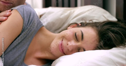 Couple in bed together, kiss and intimacy with man and woman in the bedroom, intimate and love with relationship and commitment. Young lovers happy, passion and foreplay with bonding and sensual.