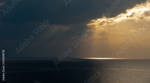 Sunrise in the sea with cloud stormy clouds and orange colour. Seascape in the morning. Sun rays in the ocean