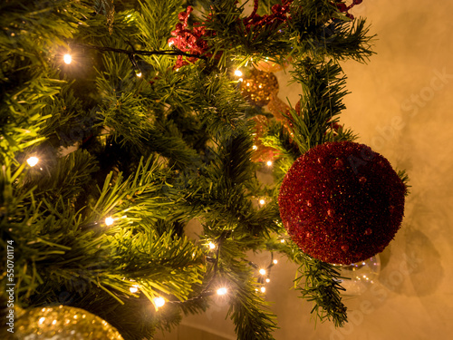 Christmas decorations on the Christmas tree and lights -Close up view of a red ball ornament