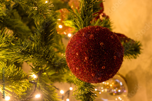 Christmas decorations on the Christmas tree and lights -Close up view of a red ball ornament