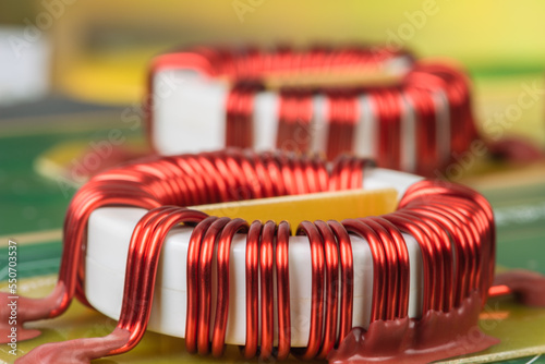 Electronic components electromagnetic coil inductor on circuit board close-up photo