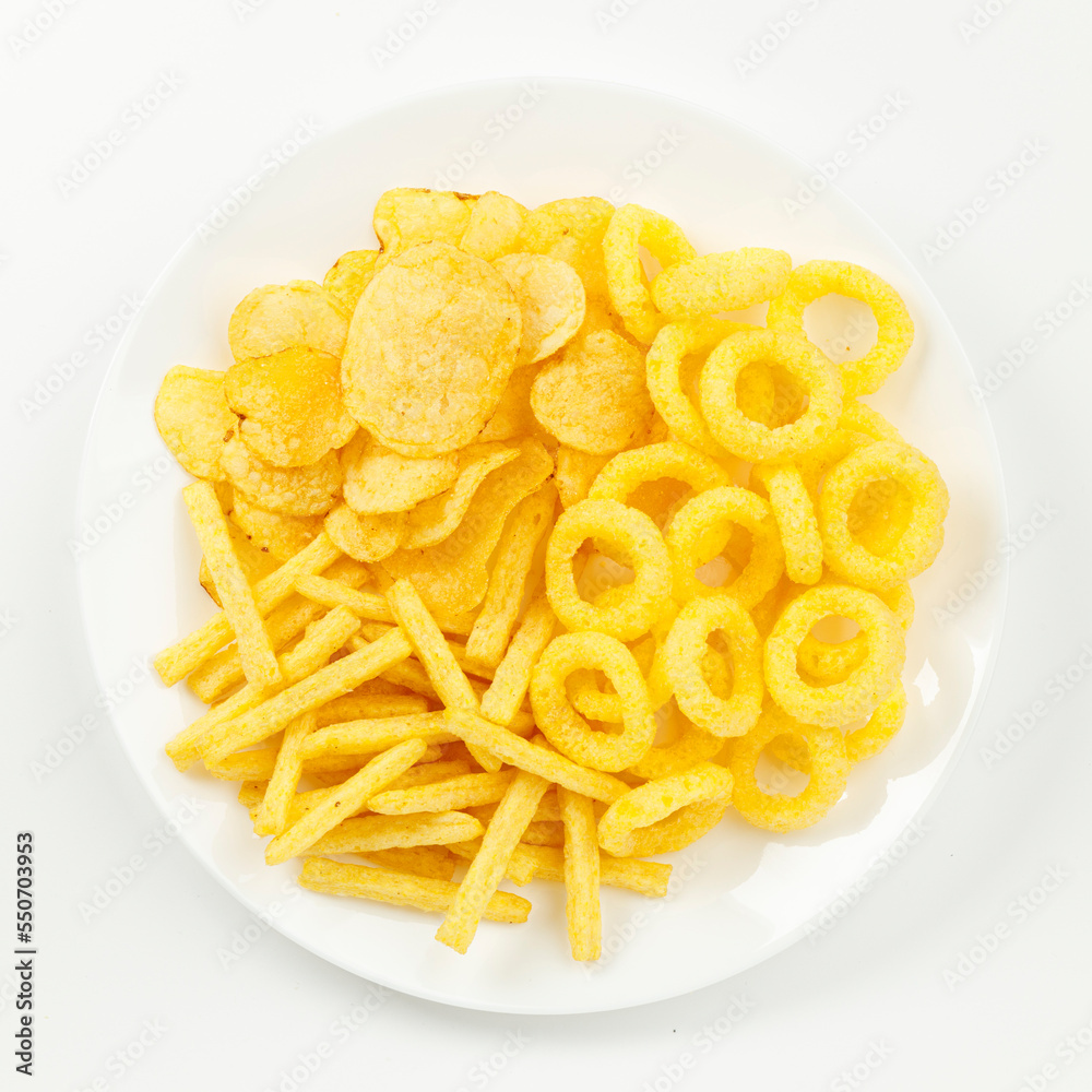 Set of corn snacks and potato chips on a white background. Set of corn snacks and potato chips on a white background.