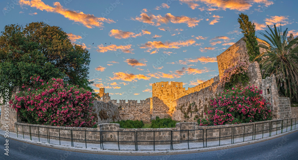 Park with flowers decorations, at city walls fortifications. Liberty Gate, Rhodes old town, Greece
