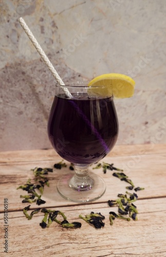 Butterfly pea tea with lemon garnish