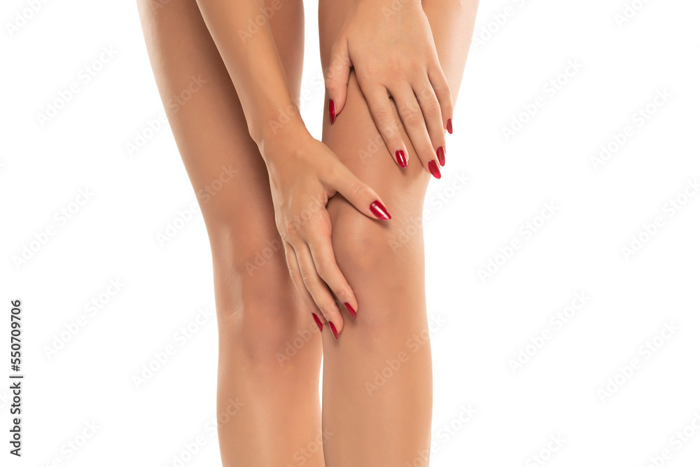 woman holding her painful knee on white background.