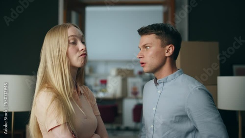 Abusive boyfriend shouting girlfriend at new home close up. Man swearing woman.