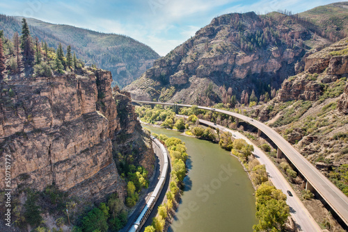 Interstate 70 (I-70) and a train beside the Colorado River in the Rocky Mountains of Colorado in autumn - - Glenwood Canyon photo