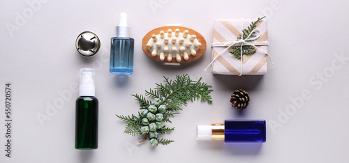 Christmas composition with cosmetic products for spa treatment on light background, top view
