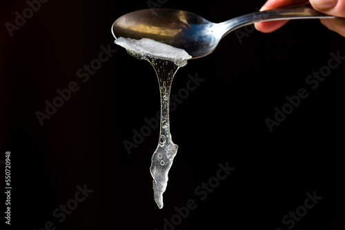 Aloe Vera pulp falling from a spoon