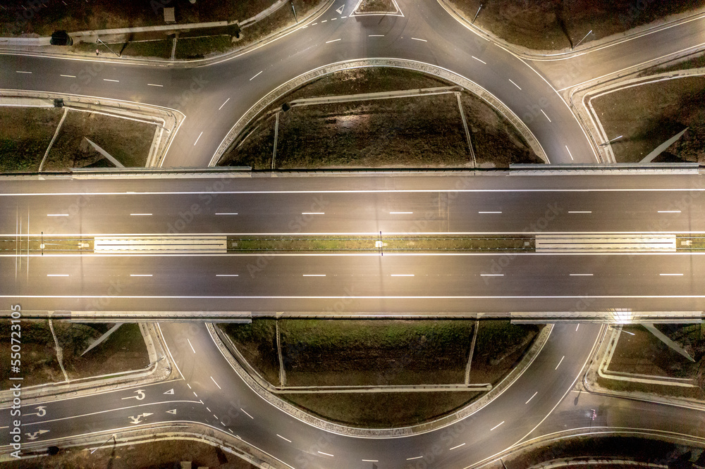 Aerial view of urban highway intersection road in the night light. Aerial view of urban highway intersection road in the night light.