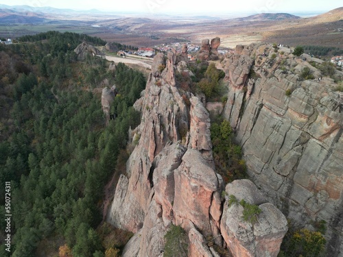 High-angle shot of rocky rough mountains surrounded by woods in Belogradchik, Bulgaria photo