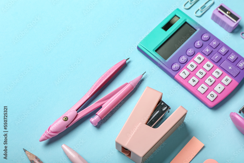 Set of different stationery with stapler on color background, closeup