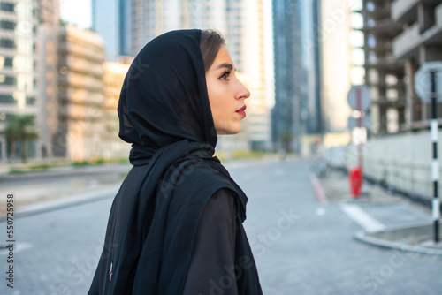 Side view portrait of beautiful Arab young woman wearing traditional arabic clothing. © Bojan