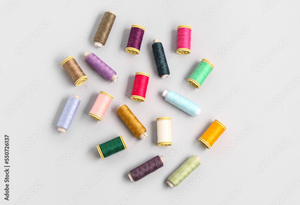 Many different thread spools on light background Many different thread spools on light background