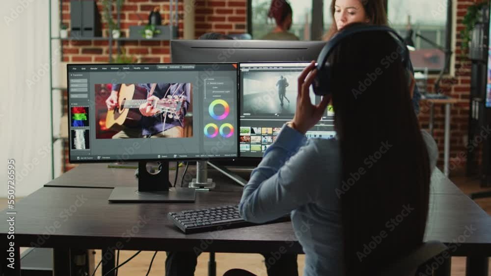 Female cinematographer editing video montage in post production studio office, improving footage quality on creative software. Artist designer working on movie or film, filmmaking industry.