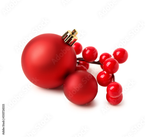 Christmas balls and red berries on white background