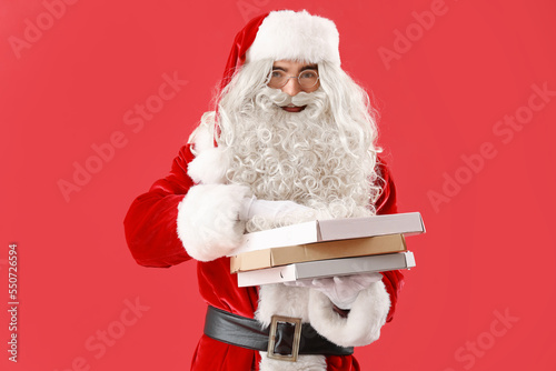 Santa Claus holding boxes w...