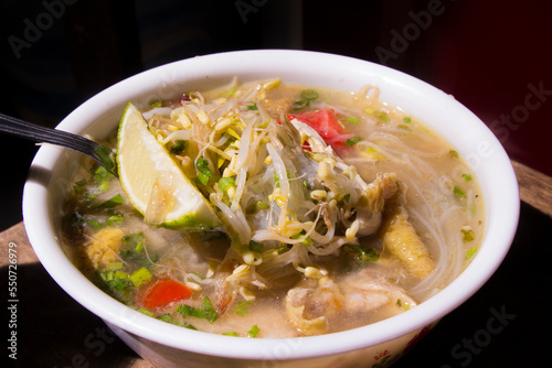 closeup, soto ayam or soto ayam in indonesia. Soto Ayam is a traditional Indonesian dish. made from vermicelli and the main ingredient is shredded chicken photo