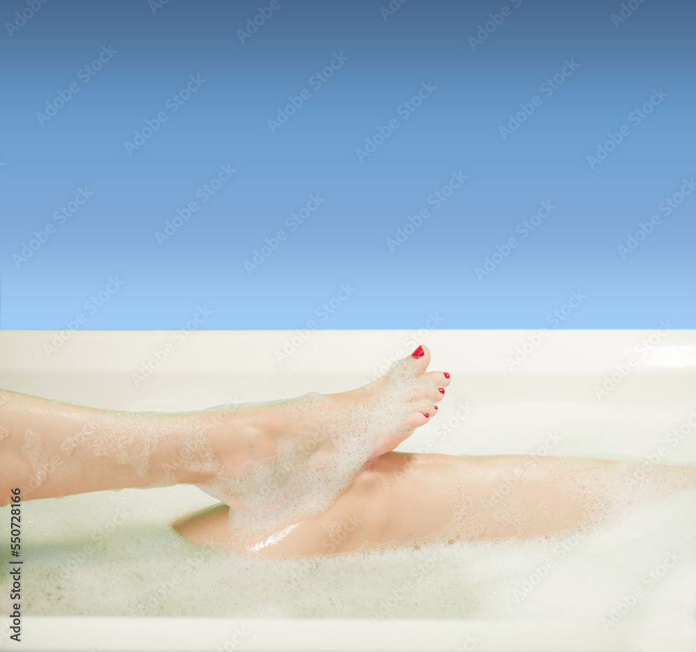 young woman hands and feet covered with foam inside white bath young woman hands and feet covered with foam inside white bath
