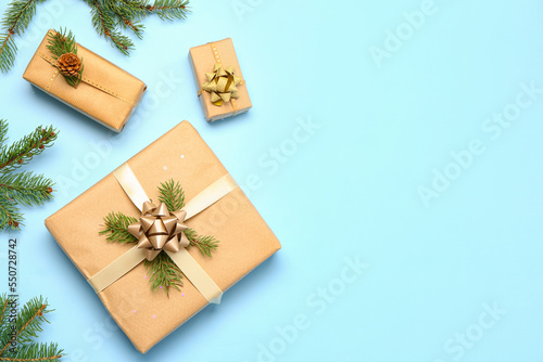 Christmas gift boxes with fir branches on blue background