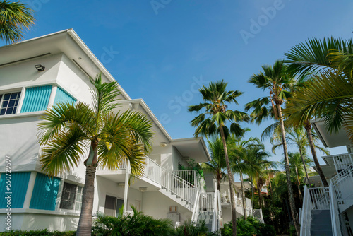 White residential buildings with staircase to the entrance near the trees outdoors- Miami, Florida © Jason