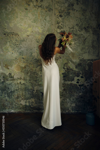 Variant of vintage shooting of the bride with a bouquet of beautiful flowers