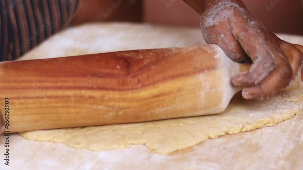 Person rolling out dough for baking. Preparing flour dough for baking pastries Person rolling out dough for baking. Preparing flour dough for baking pastries