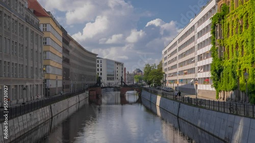 Day Berlin time lapse. Spree river and the Jungfern Bridge. Spree river and the Jungfern Bridge. Jungfern Bridge, oldest bridge in Berlin, dated from 1798, spanning the Spree at the Kupfergraben.  photo