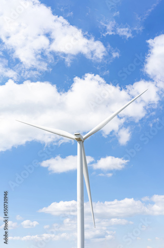 Wind turbines in the blue sky on a sunny day, produced electricity from pure energy. © Surachetsh