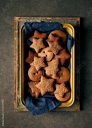 Homemade gingerbread cookies in a baking tray. Christmas baking. Top view