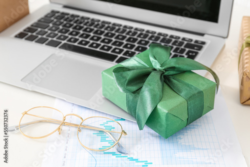 Laptop with Christmas gift,...
