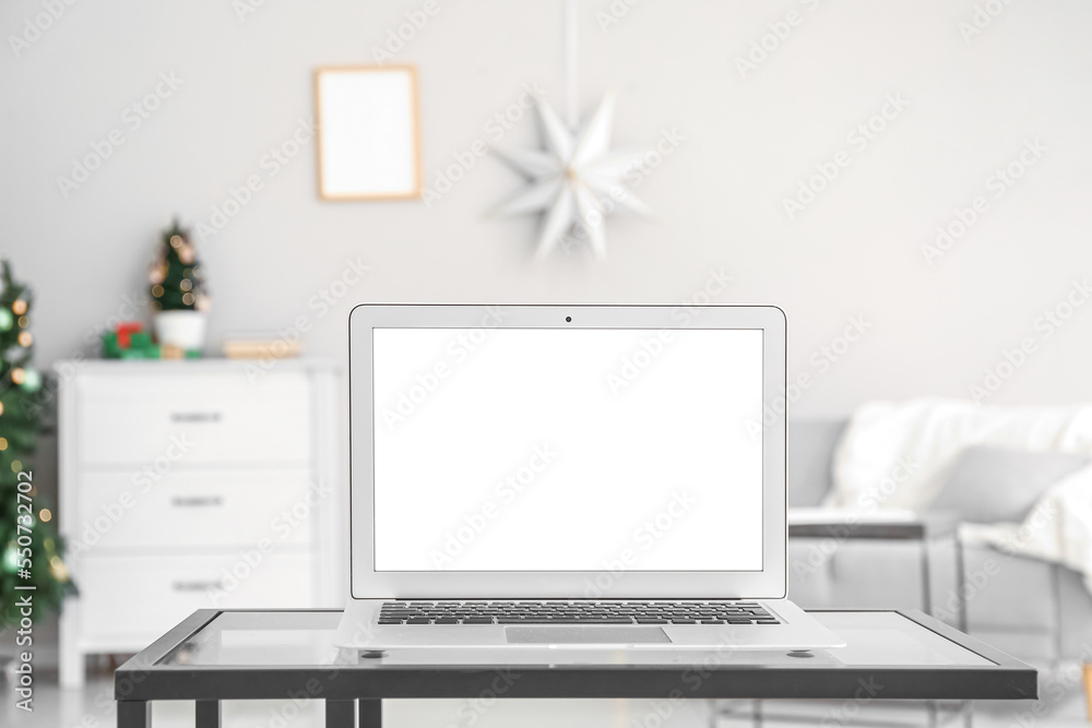 Fototapeta premium Table with laptop in office on Christmas eve