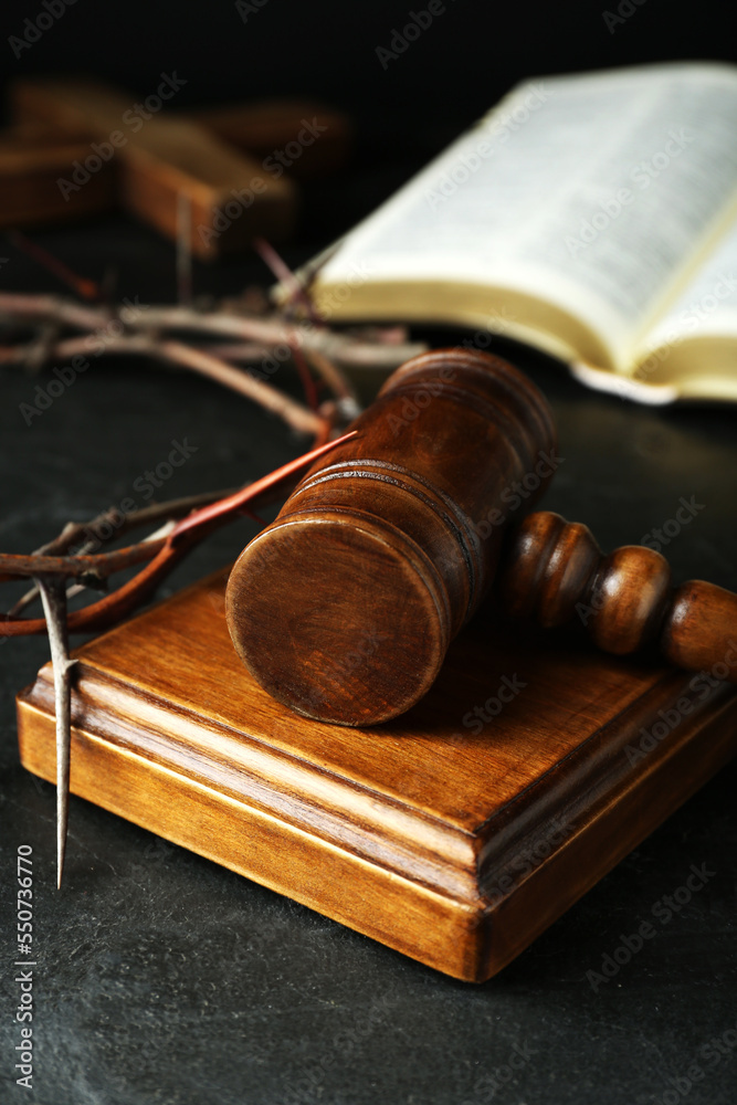 Wooden judge gavel and crown of thorns on black table, closeup Wooden judge gavel and crown of thorns on black table, closeup