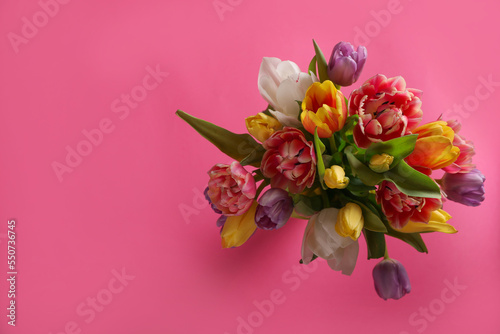 Bouquet of beautiful tulips on pink background  top view. Space for text