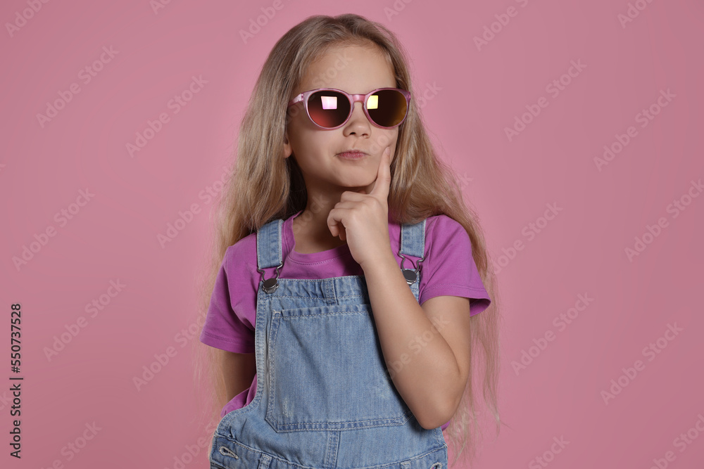 Girl in stylish sunglasses on pink background Girl in stylish sunglasses on pink background