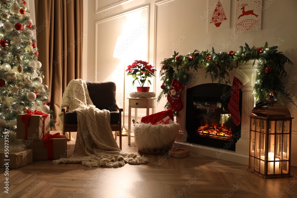 Fototapeta premium Stylish room interior with fireplace and beautiful Christmas tree