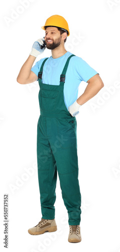 Professional repairman in uniform talking on smartphone against white background