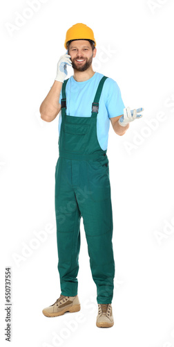 Professional repairman in uniform talking on smartphone against white background