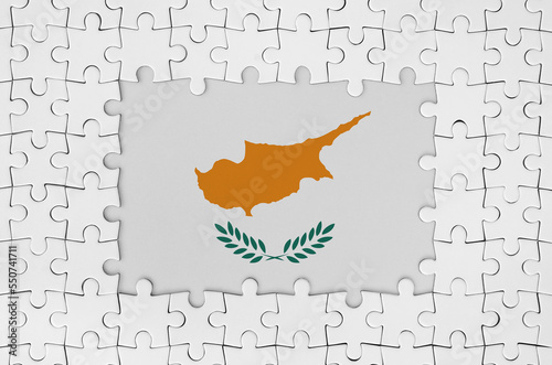 Cyprus flag in frame of white puzzle pieces with missing central parts photo