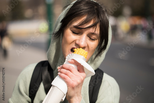 woman eating corn. Happy day. Corn. Eating. Happy day