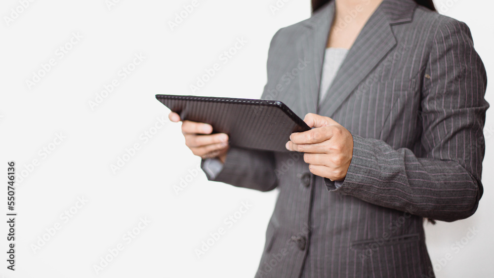 Asian businesswoman working at home using tablet device, browsing internet playing social media in video call meeting with colleagues and coworkers planning innovative ideas, quarantine self-isolation Asian businesswoman working at home using tablet device, browsing internet playing social media in video call meeting with colleagues and coworkers planning innovative ideas, quarantine self-isolation